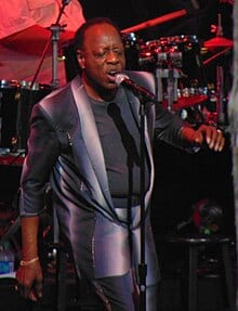 Fambrough singing into a microphone onstage